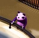 a purple panda bear is standing on a railing on a skateboard .