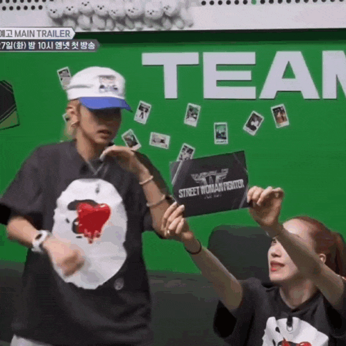a couple of people standing in front of a sign that says team