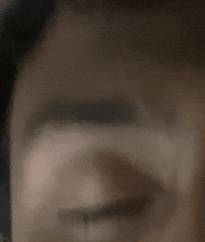 a close up of a person 's eye with a few teeth showing
