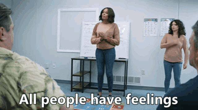 a woman stands in front of a group of people with the words " all people have feelings " above her