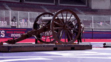 a cannon sits in front of an ohio stadium banner