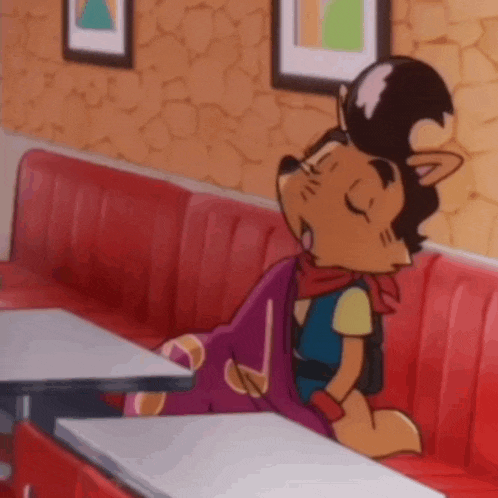 a cartoon character is sitting on a red couch .