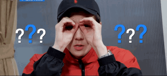 a person covering their eyes with their hands and a blue question mark