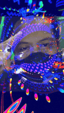 a man wearing a mask and glasses is surrounded by a colorful painting .