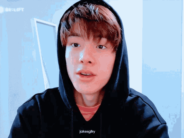 a young man wearing a black hoodie that says jakesglrry