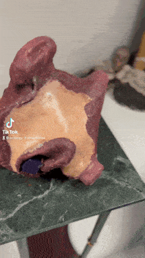 a sculpture of a face is on a table and has a tik tok sticker on it