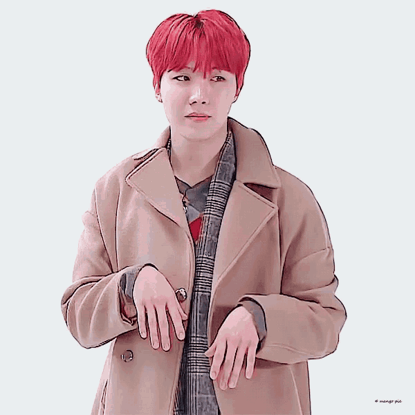 a man with red hair is wearing a tan coat and plaid shirt