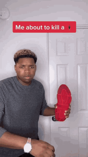 a man is holding a red shoe with the words me about to kill a on the bottom