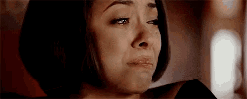 a close up of a woman 's face with a tear running down her cheek .