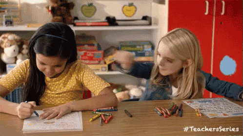 two girls are sitting at a table with crayons and a sign that says teachers series