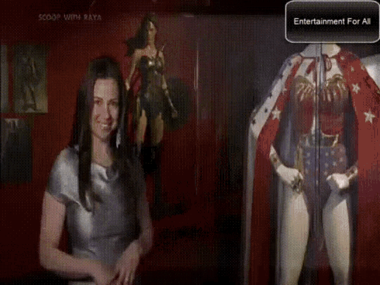 a woman is standing in front of a display of wonder woman costume