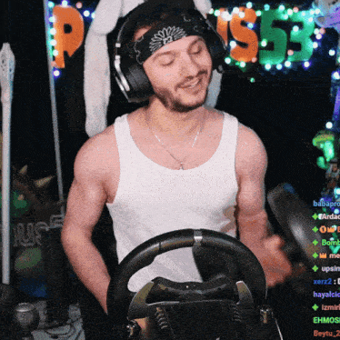 a man wearing headphones and a bandana stands in front of a sign that says " p55 "