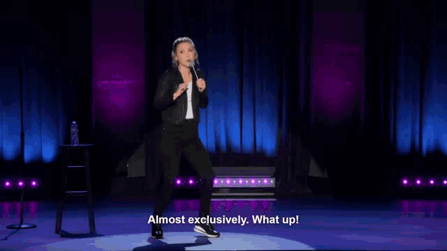 a woman stands on a stage and says " almost exclusively "