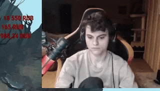 a young man is sitting in a chair with headphones on .