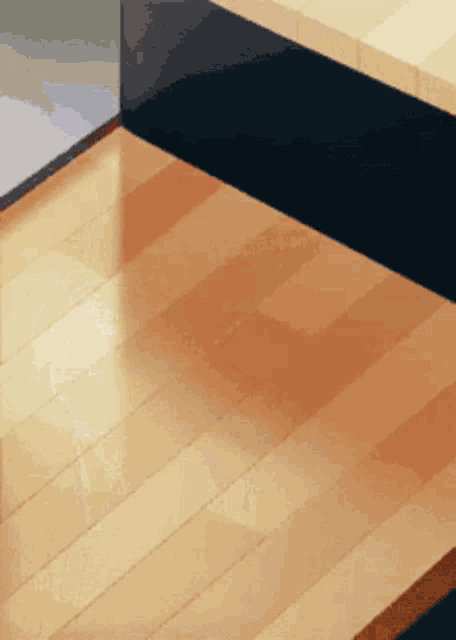 a close up of a wooden floor with a black stripe