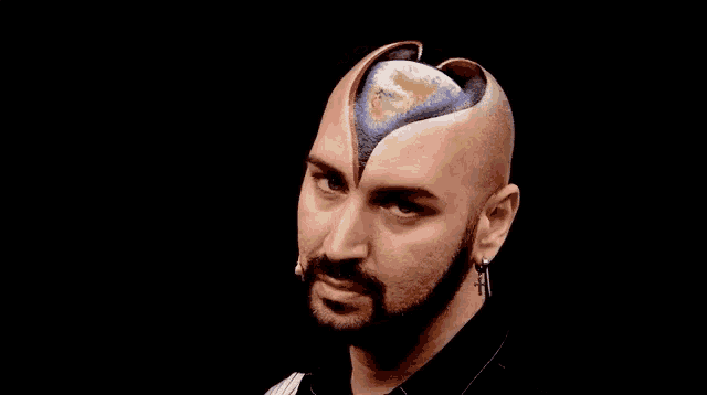 a man with a beard has a picture of the earth painted on his head .
