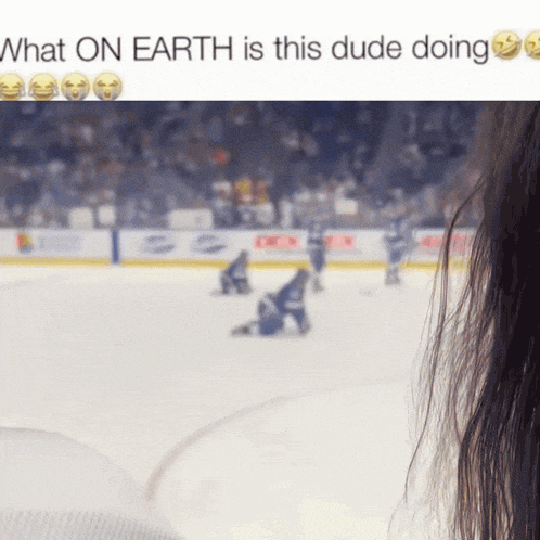 a blurred image of a hockey game with the words what on earth is this dude doing below it
