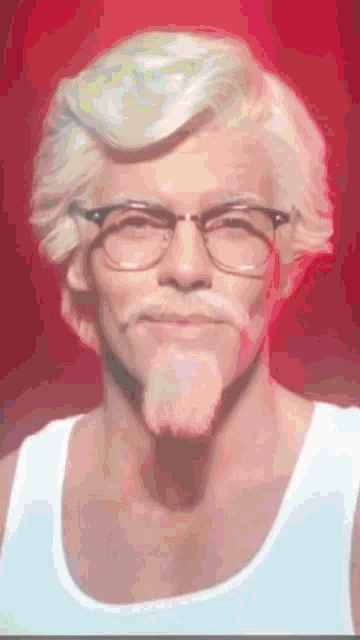 a man with glasses and a beard wearing a tank top