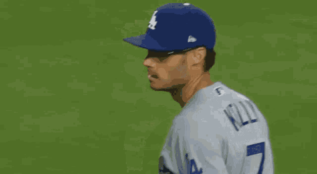 a baseball player named kelly is wearing sunglasses and a blue hat
