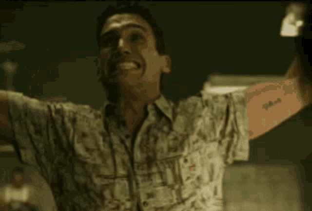 a man with his arms outstretched is wearing a shirt that says ' hawaiian ' on it