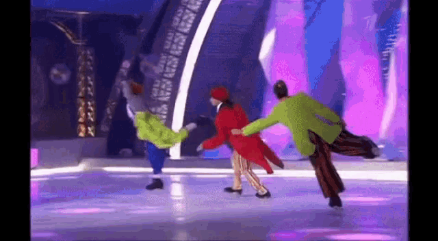 a group of people are dancing on a stage on ice .