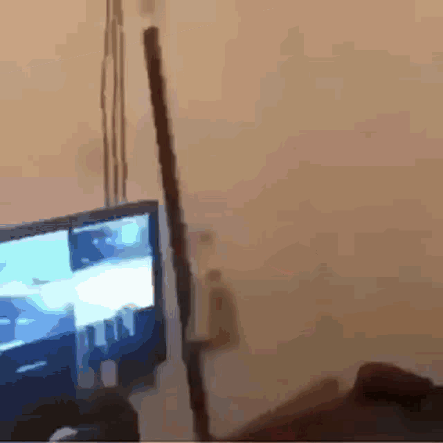 a person is playing a video game on a television in a living room .