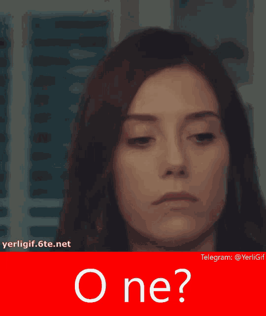 a woman 's face is behind a red cap that says " o ne "