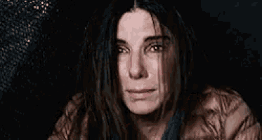 a close up of a woman 's face with tears running down her cheeks .