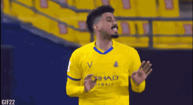 a soccer player wearing a yellow shirt with the word airways on it is making a funny face .