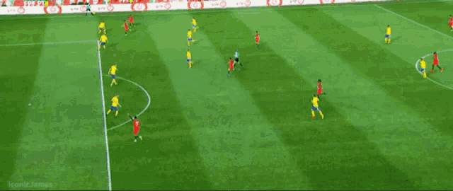 a group of soccer players are playing on a field and one of them has the number 12 on his jersey