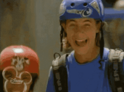 a person wearing a blue helmet and a blue shirt with disney on it