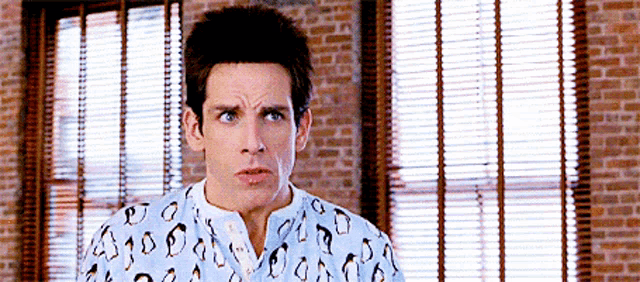 a man wearing a shirt with penguins on it