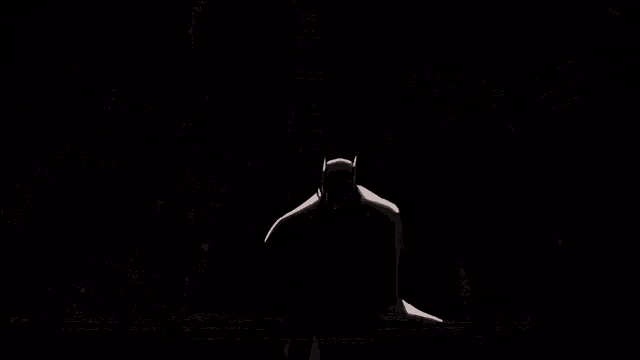 a black and white cartoon of batman standing in front of a city at night