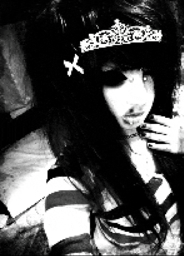 a black and white photo of a girl wearing a tiara