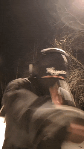 a blurry picture of a person wearing a mask and a hat that says supreme on it