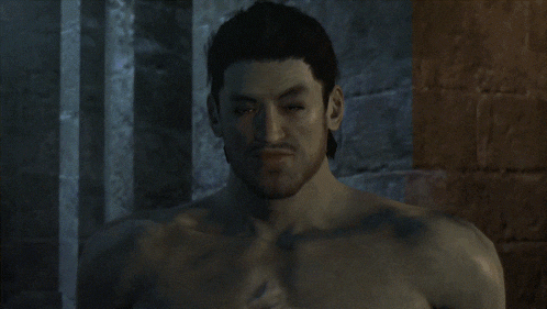a man without a shirt is standing in front of a stone wall