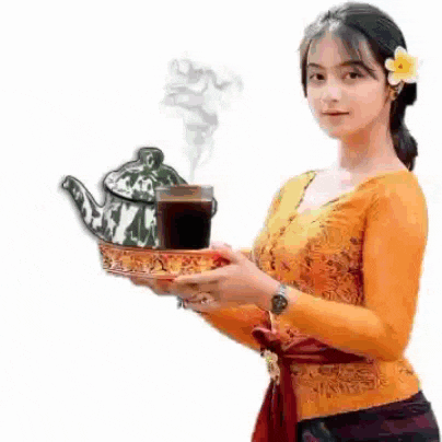 a woman is holding a tray with a teapot and a cup of tea .