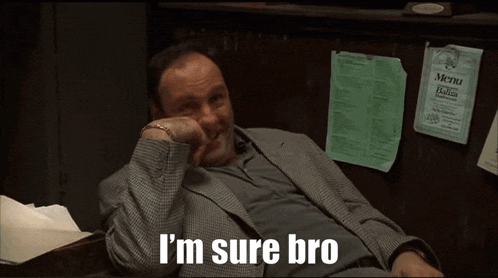a man in a suit sits in front of a menu that says i 'm sure bro