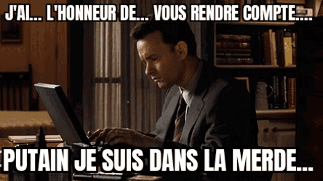 a man in a suit and tie is typing on a laptop with a caption that says j'ai