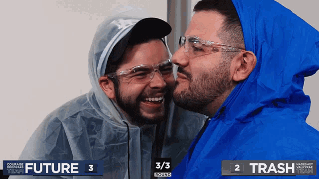 two men are kissing each other in front of a scoreboard that says trash