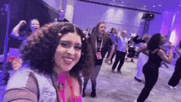 a woman taking a selfie with a lanyard around her neck that says ' amanda ' on it