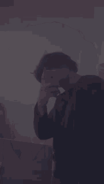 a man is taking a picture of himself with his iphone