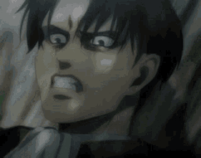 a close up of a man 's face with a very angry expression .