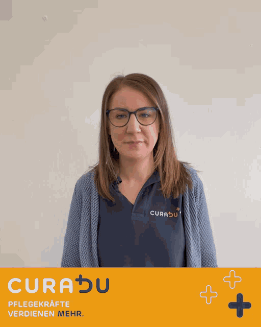a woman wearing glasses and a curadu shirt