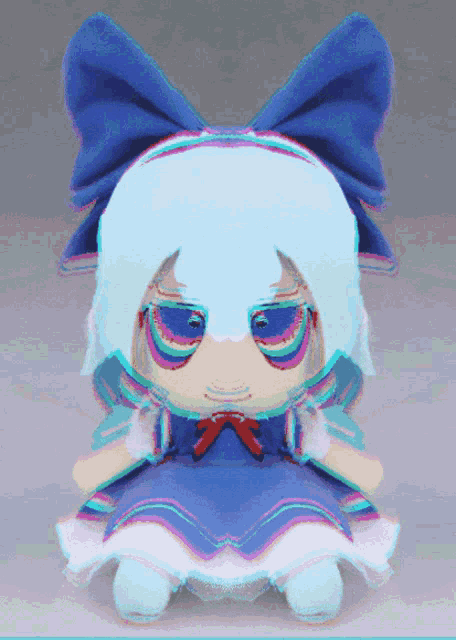a blue and white stuffed doll with a blue bow