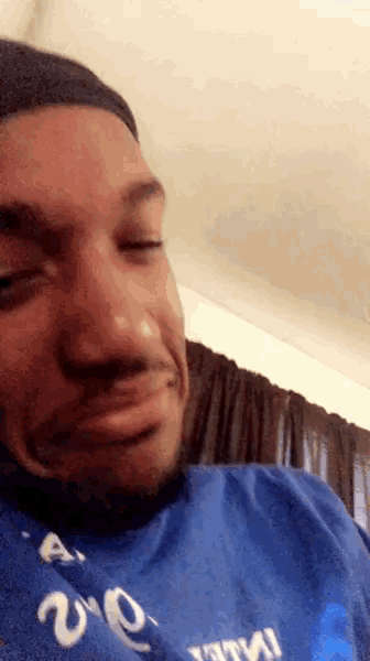 a man is wearing a blue shirt that says ' a ' on it