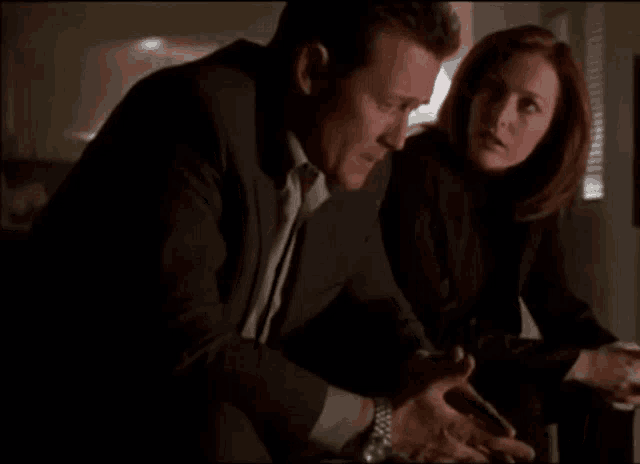 a man and a woman are sitting at a table and talking
