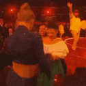 a blurry picture of a group of people standing in a room .
