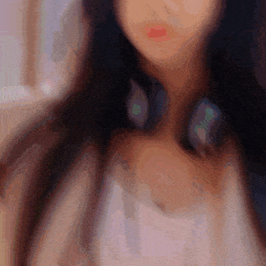 a blurred image of a woman wearing headphones