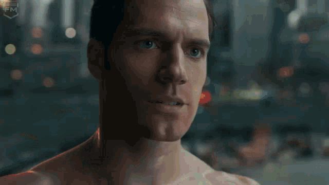 a shirtless man is standing in front of a burning car in a city park